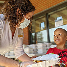 Child3-(1) masked volunteer helping a young boy