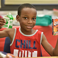SummerMeals smiling boy with his lunch