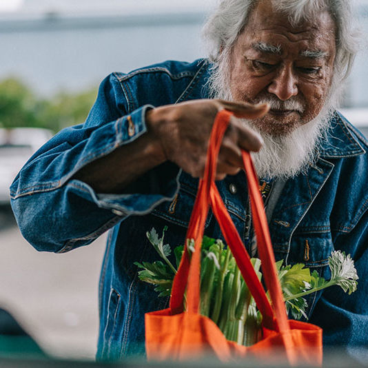 Circle-CSFP older gentleman holding a bag of produce